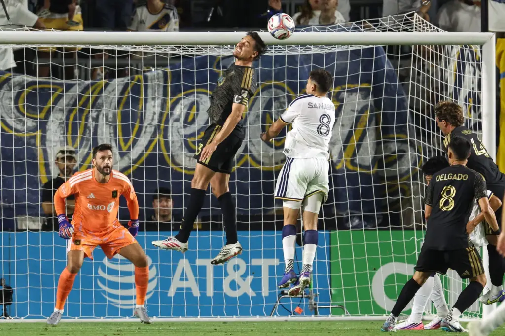 LAFC defender Aaron Long, top, heads the ball during the...