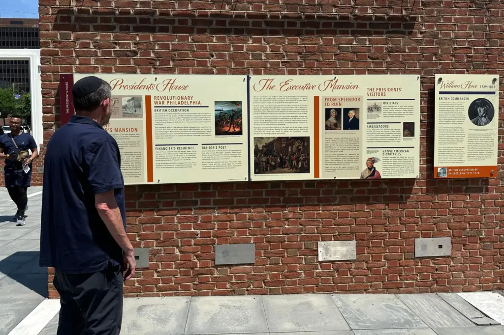 Visitors view the reinstalled educational panels about slavery at the...