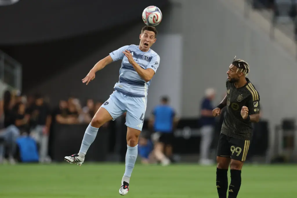 Sporting Kansas City midfielder Lasse Berg Johnsen (4) heads the...