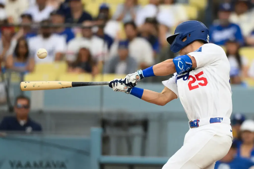 Dodgers’ Tommy Edman hits a two-run single during the third...
