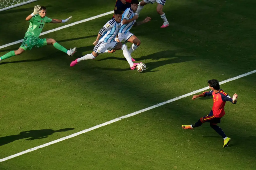 Spain’s Ferran Torres (7) scores the opening goal of his...