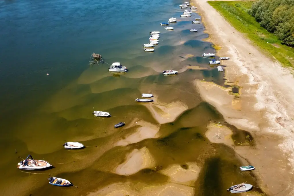 Boats sit on a bank of the Danube River where usually submerged areas are exposed.