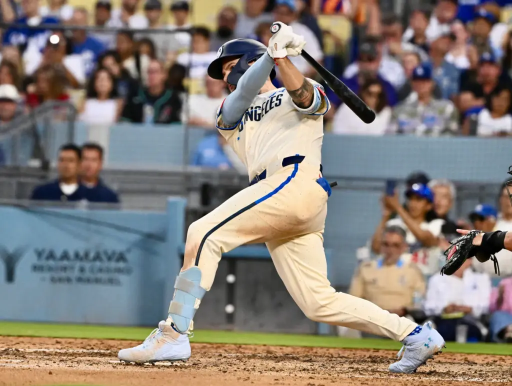 Andy Pages of the Dodgers hits an RBI single as...