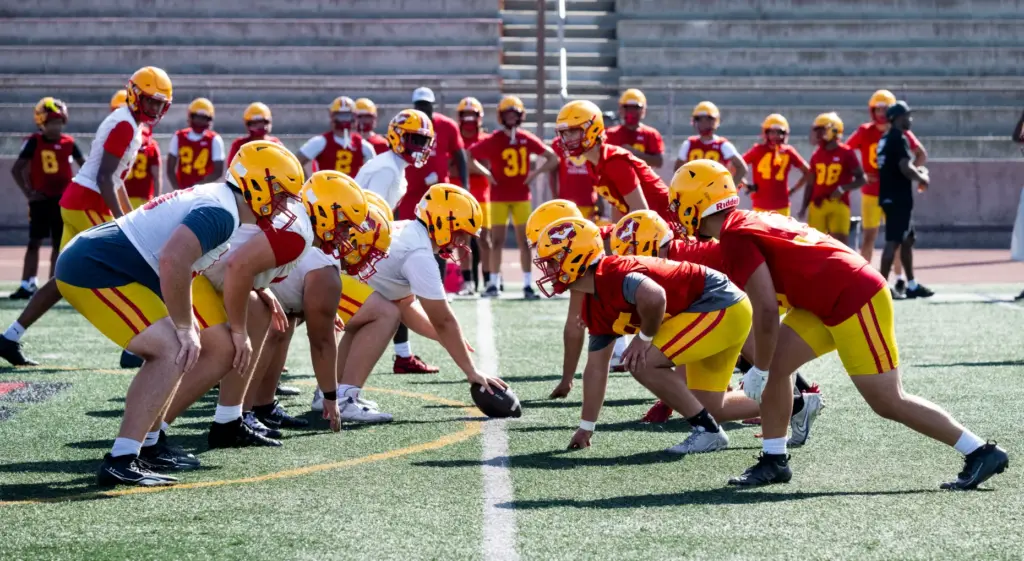 The Mission Viejo High School football team runs plays during...