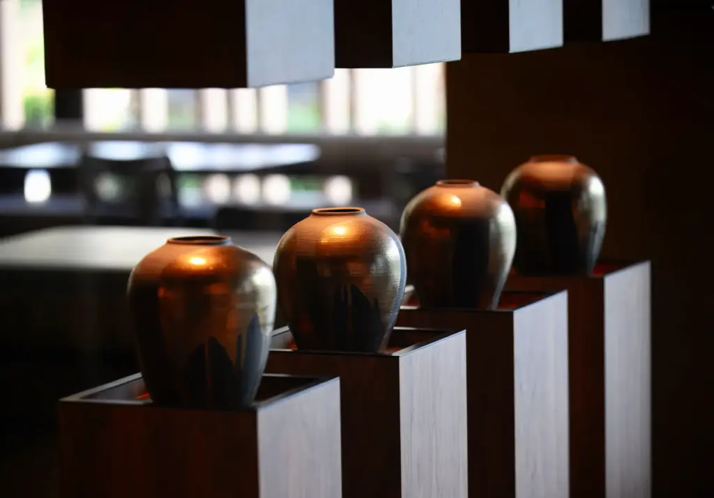 A row of vases separates the waiting area from the...