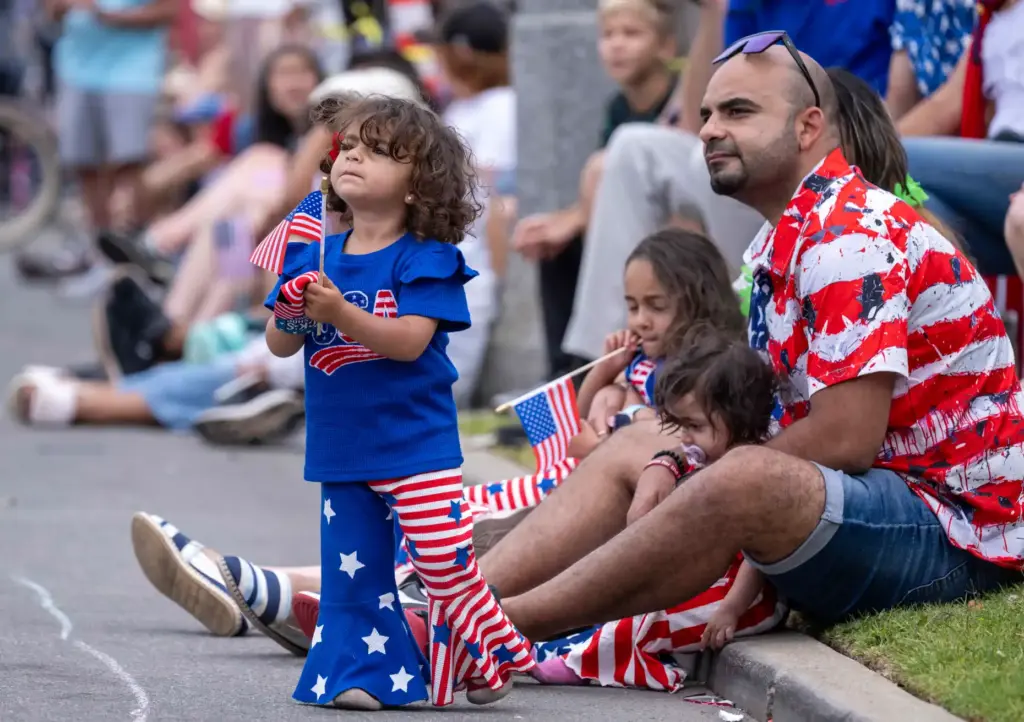 Miriam Apadir, 2, of Westminster holds an American flag as...