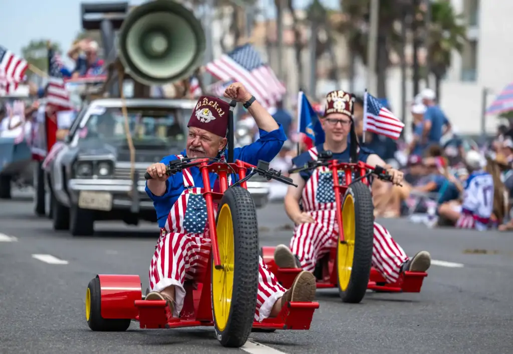 Shriners volunteers drive giant tricycles along Pacific Coast Highway in...