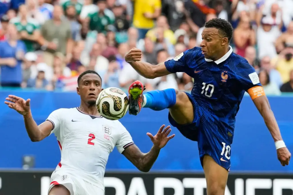 France’s Kylian Mbappe (10) takes a shot as England’s Ezri...