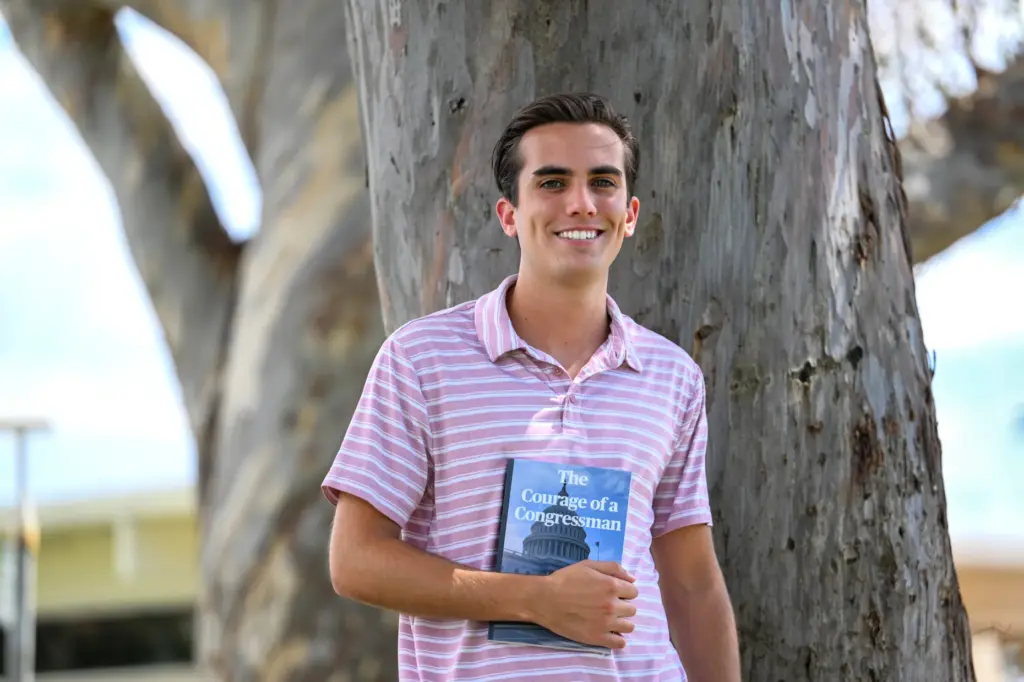 Recent high school graduate Kevin McGowan with his book, âCourage...