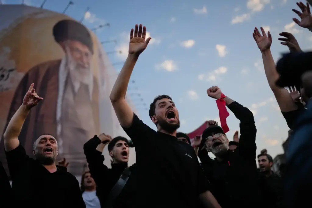 Mourners chant slogans while gathered in Islamic Revolution Square for the funeral procession.