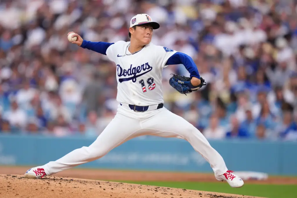 Dodgers starting pitcher Yoshinobu Yamamoto throws to the plate during...