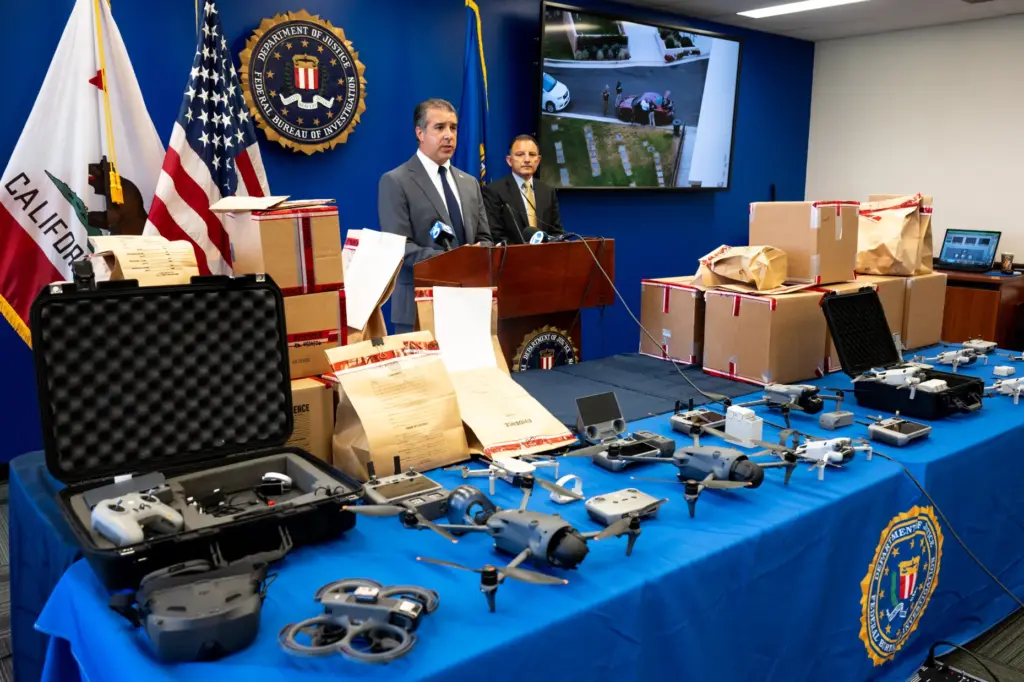 The FBI’s Patrick Grandy, at the lectern, shows off some...
