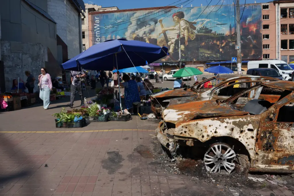 Destroyed cars sit after a Russian attack at the market...