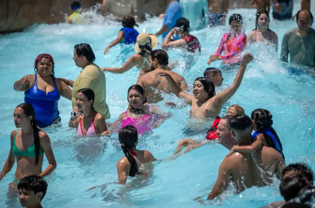 Families cool off in the Shaka Bay wave pool at...