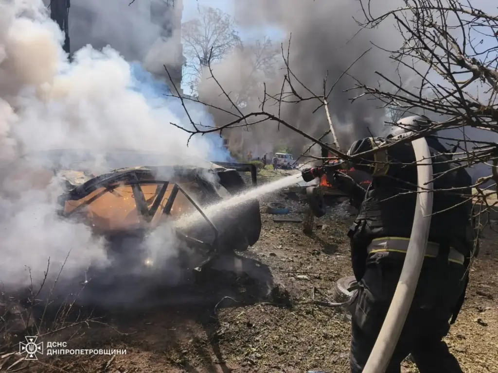 Firefighters put out a fire in a residential building following a Russian air attack