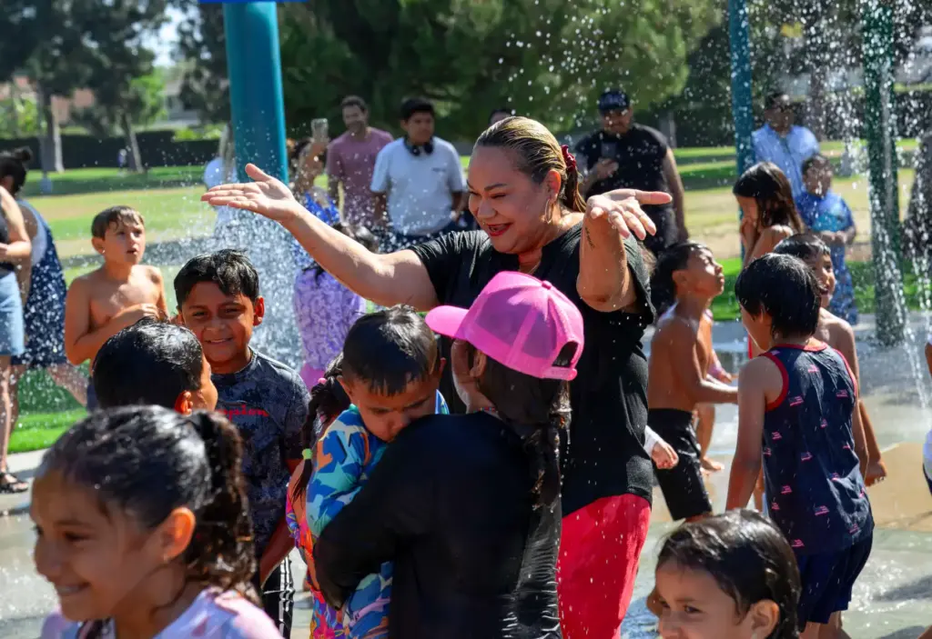 Santa Ana Mayor Valerie Amezcua, center, joins kids in trying...