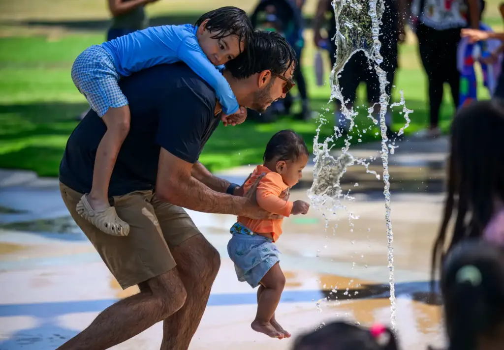 Gerardo Huerta of Santa Ana plays with his kids, Rafael,...