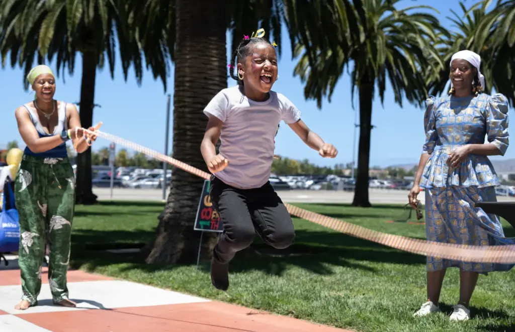 Lorena Luke, 7, does the Double Dutch jump rope during...