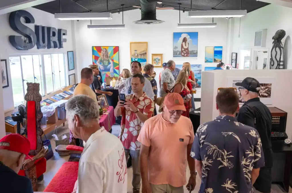 Visitors check out the Surf Art Corner room, featuring surf...