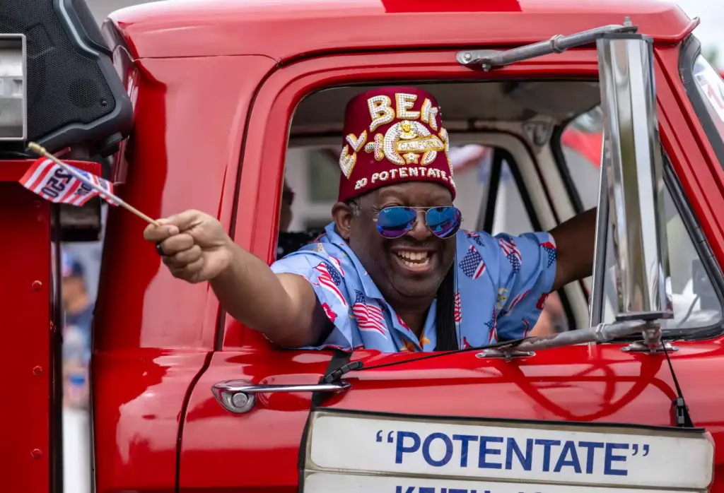 Keith Jones, representing the El Bekal Shrine in Anaheim, waves...