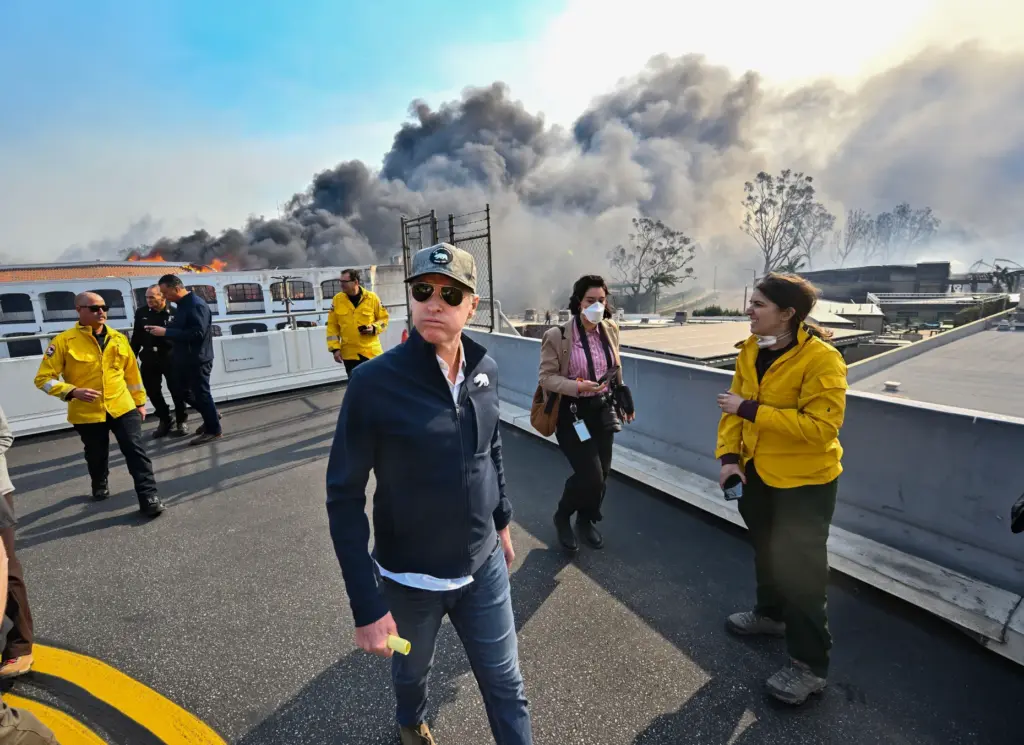 California Gov. Gavin Newsom, center, surveys damage during the Palisades...
