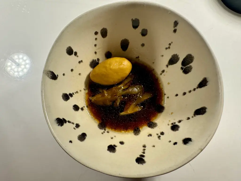 Black cod and cuttlefish quenelle with porcini broth. (Photo by...