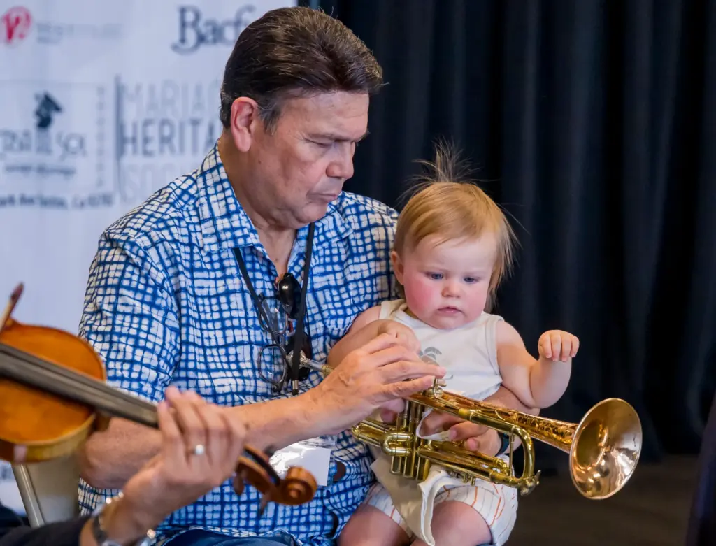 Master Musician JosÃ© HernÃ¡ndez shows his one-year-old grandchild, Nico Altavilla,...