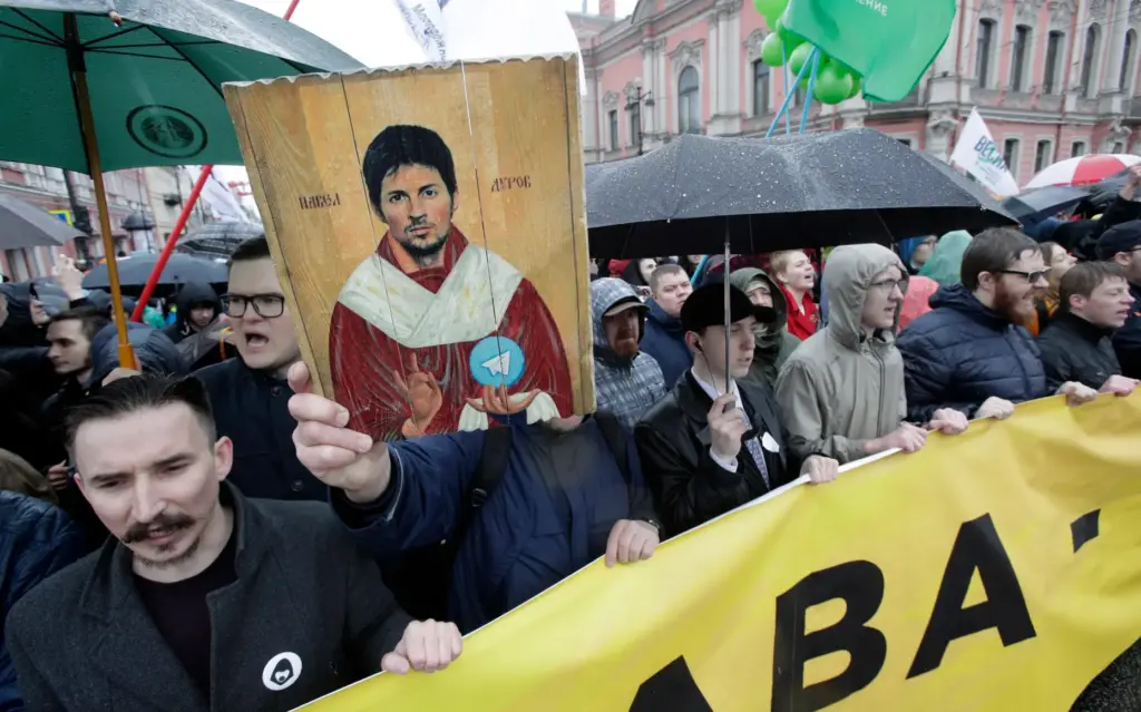 Protesters hold a portrait of messaging app Telegram co-founder Pavel Durov.