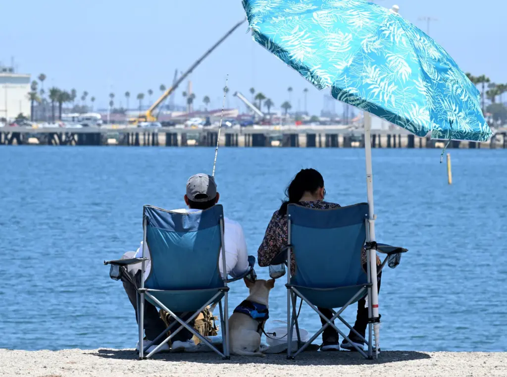 Anglers keep it cool at the Cabrillo Beach breakwater in...