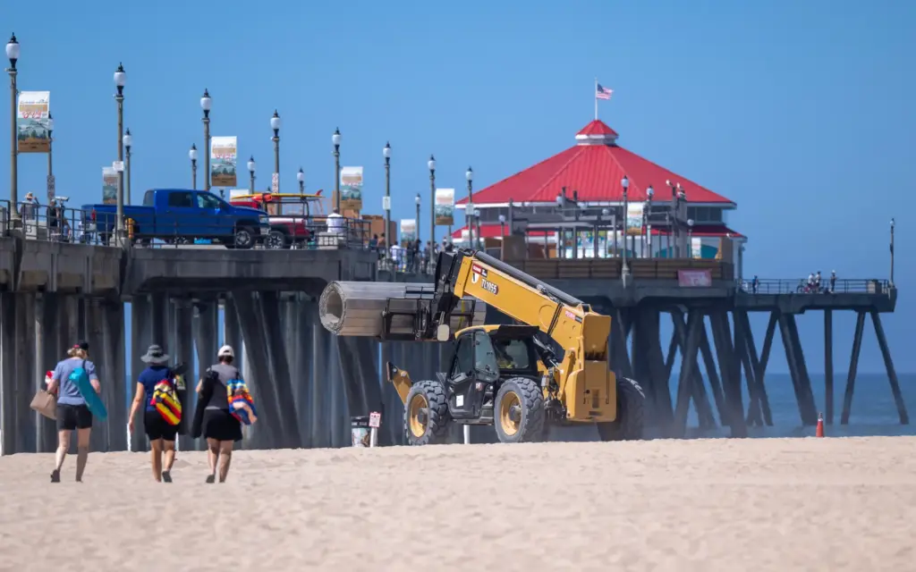 Workers use heavy equipment to construct the elaborate infrastructure for...