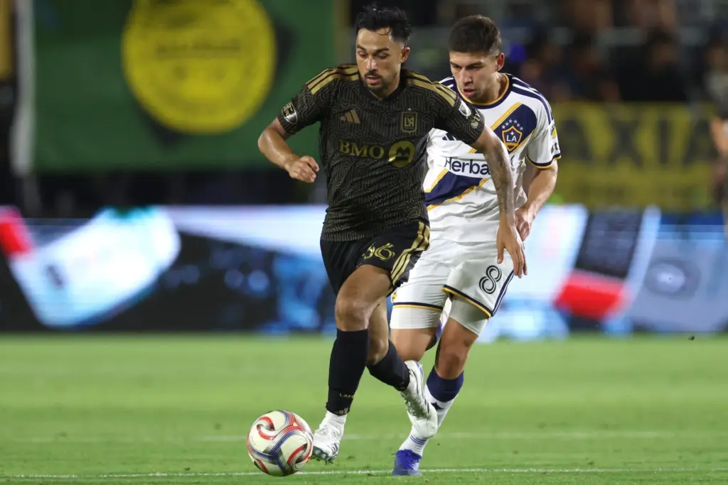 LAFC midfielder Mathieu ChoiniÃ¨re moves the ball up the field...