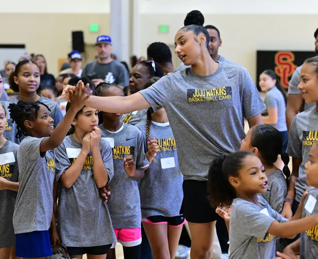 JuJu Watkins high fives some of the girls in the...
