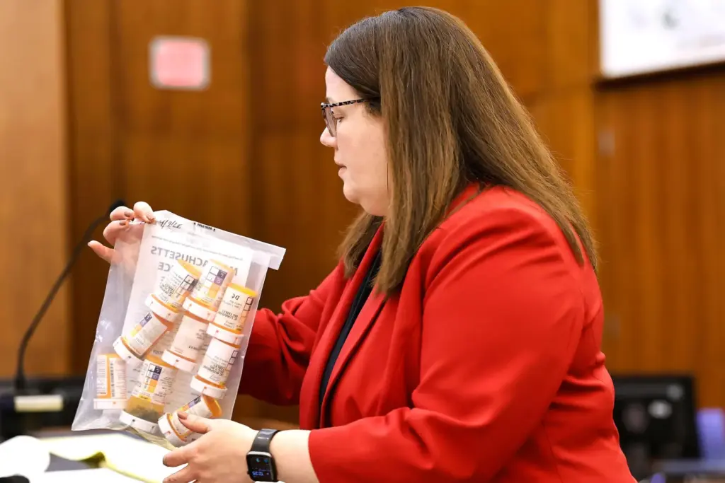 Prosecutor Jennifer Sprague enters a bag of prescription pills as evidence.
