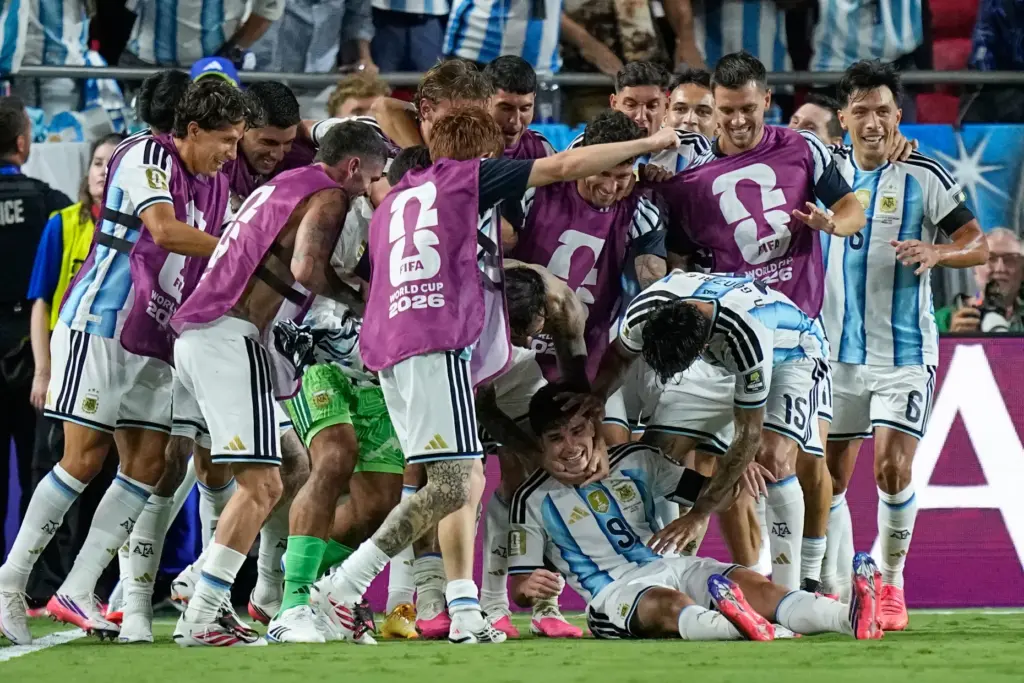 Argentina’s Julian Alvarez (9) is congratulated by teammates after scoring...