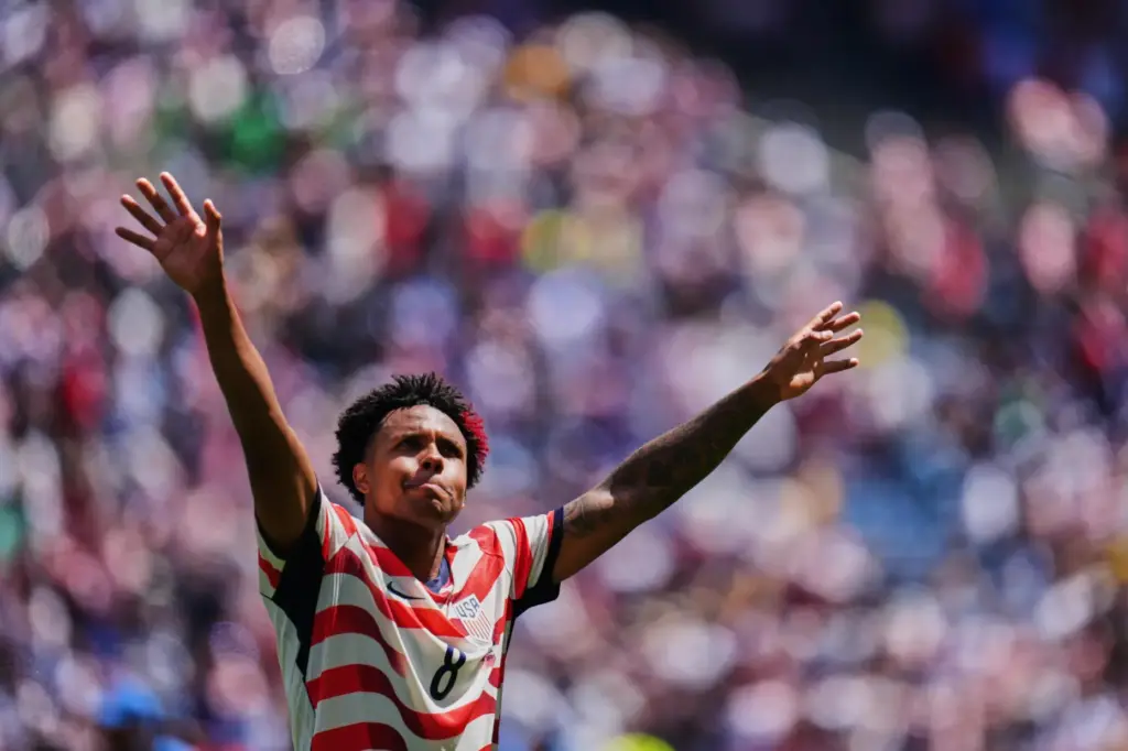 United States’ Weston McKennie (8) celebrates after winning the World...
