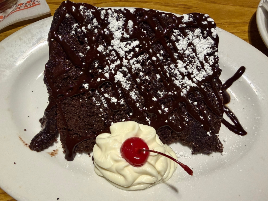 A colossal slice of chocolate cake is seen at Damonâs...