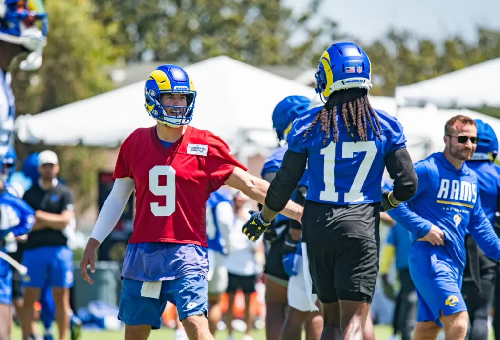 Los Angeles Rams quarterback Matthew Stafford (left) high fives wide...