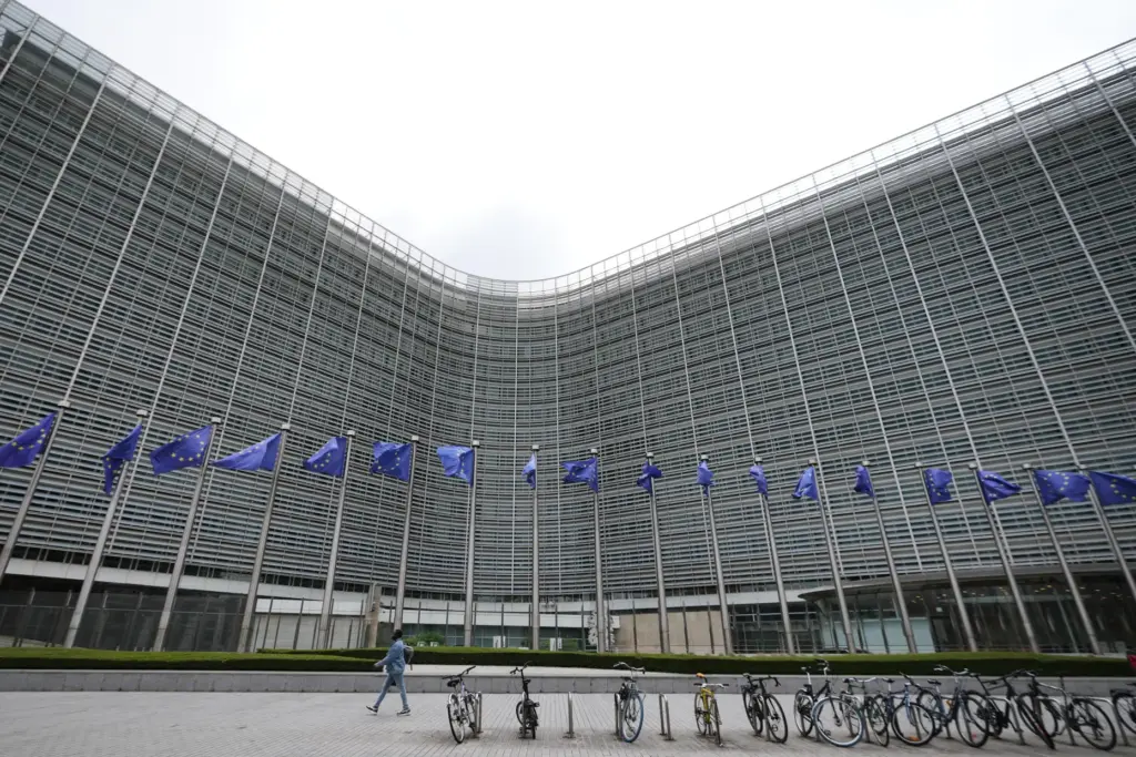 European Union flags flap in the wind outside EU headquarters in Brussels.