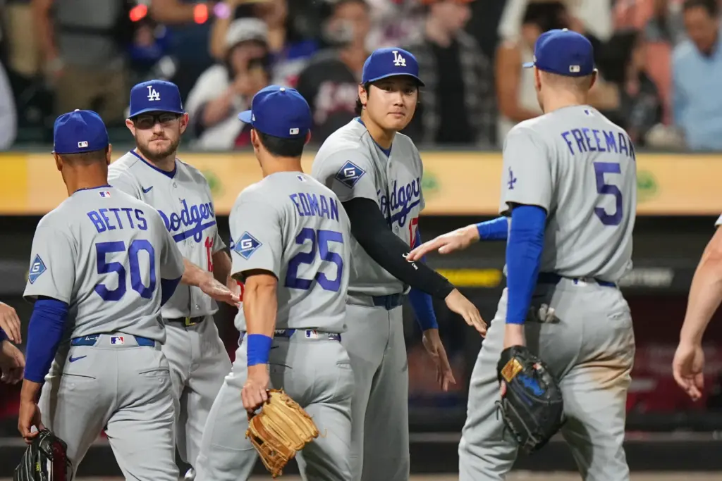 Dodgers’ Shohei Ohtani , center, celebrates with teammates after a...