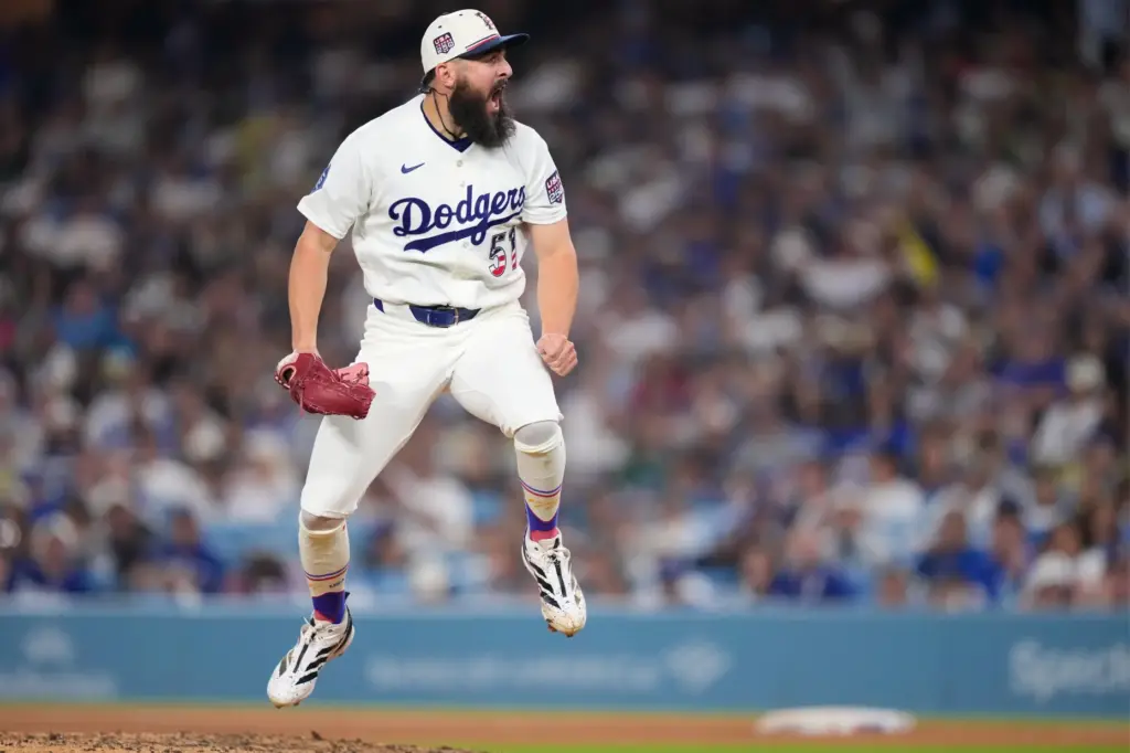 Dodgers pitcher Alex Vesia reacts after striking out San Diego...