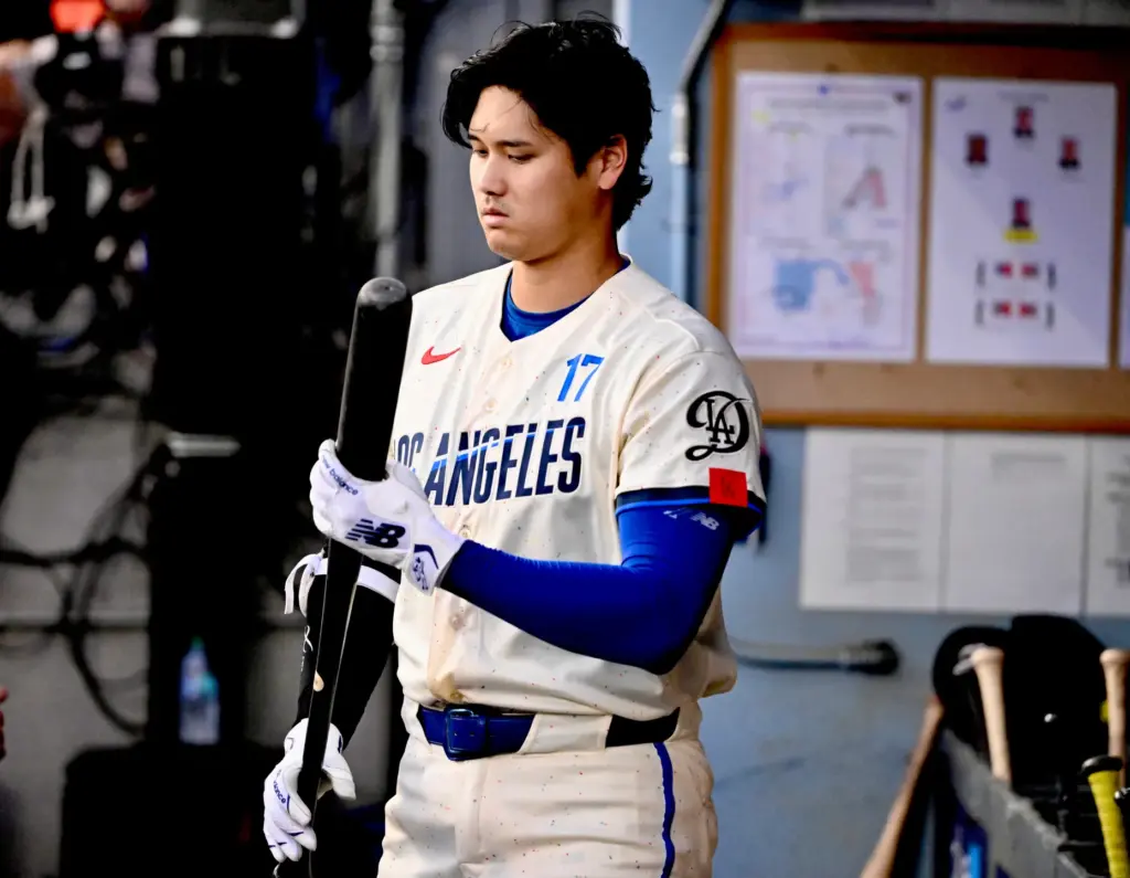 Shohei Ohtani of the Dodgers waits his turn at bat...