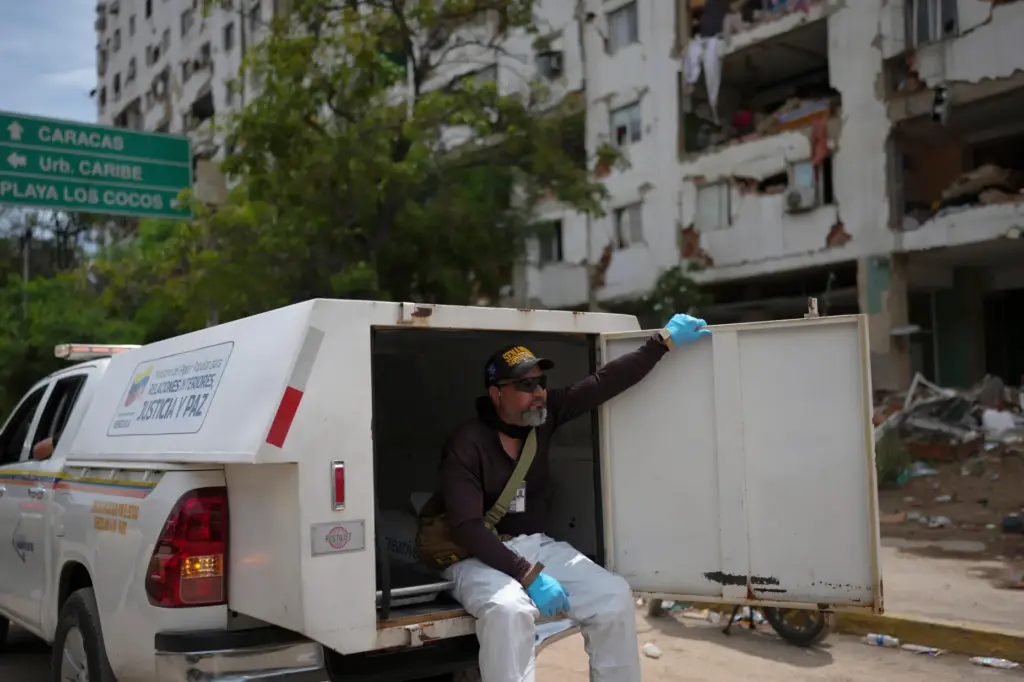 Forensic technician Joel Mirabal rides through the area struck by...