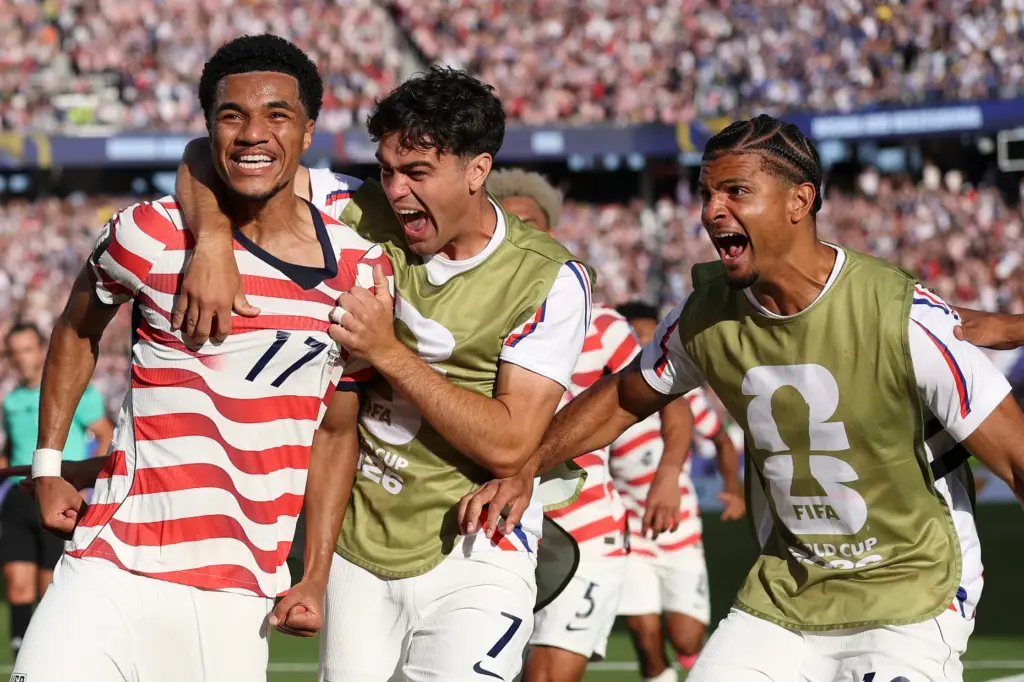 The United States’ Malik Tillman (17) celebrates with teammates after...