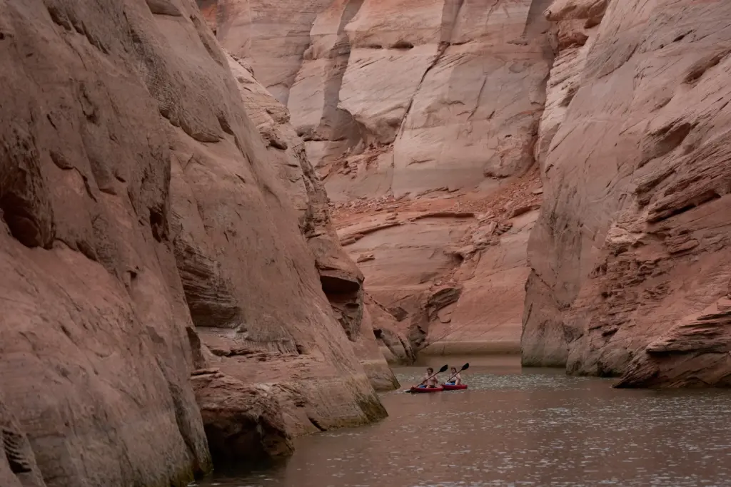 People paddle through a canyon on Lake Powell at the...