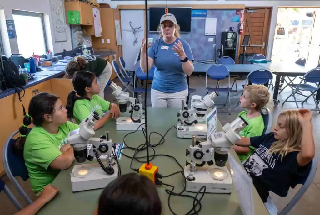 Laura Sanborn, center, a camp counselor at the Ocean Institute,...