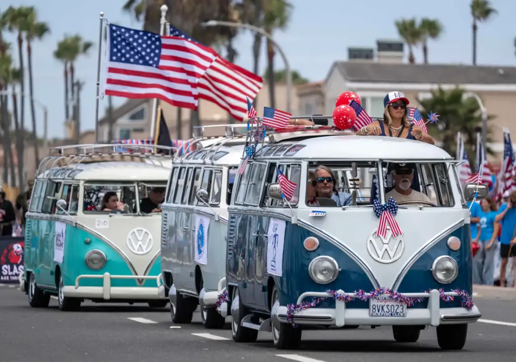 The Cowabunga Van Clan members drive vintage Volkswagen vans along...