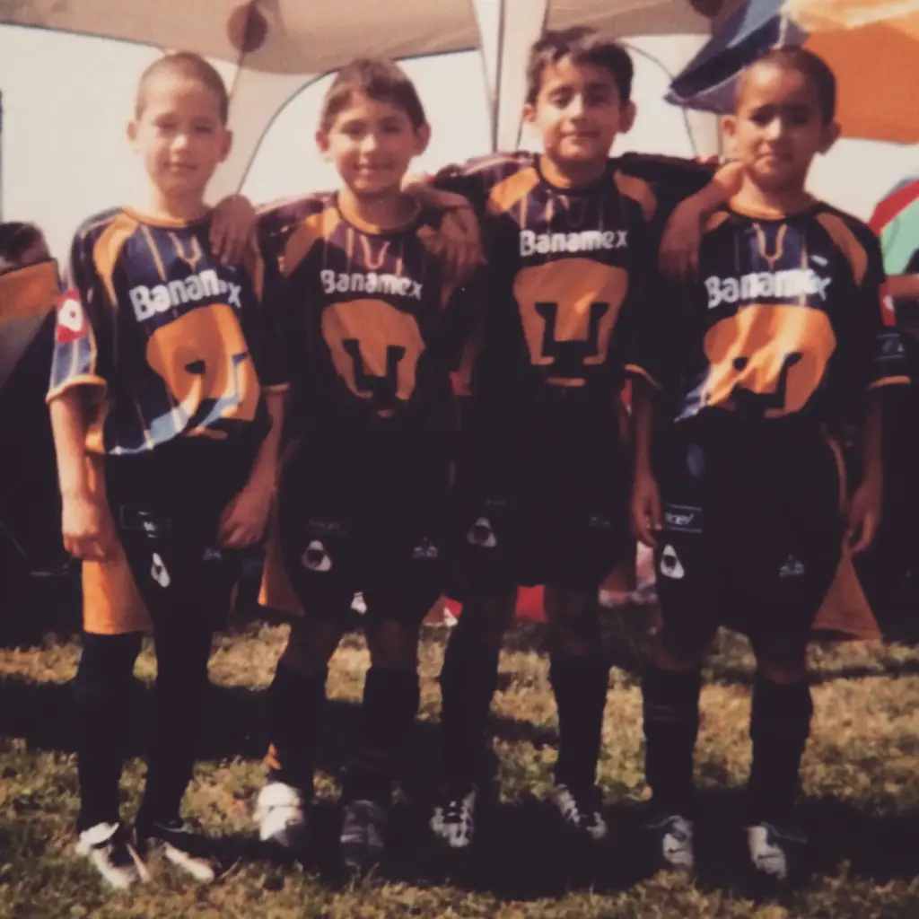 Cristian Roldan poses for a photo during his childhood with...