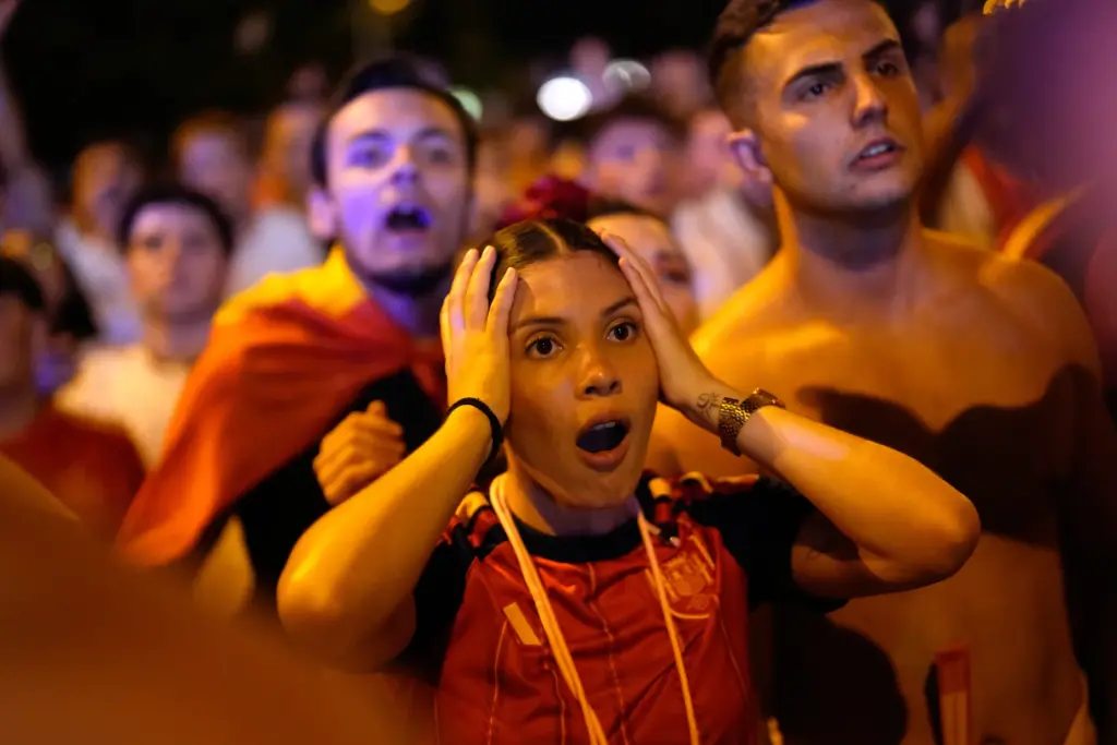 Spanish fans react while watching the World Cup final soccer...