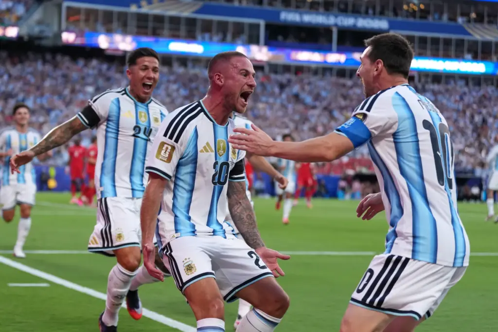 Argentina’s Alexis Mac Allister, center, celebrates scoring their first goal...