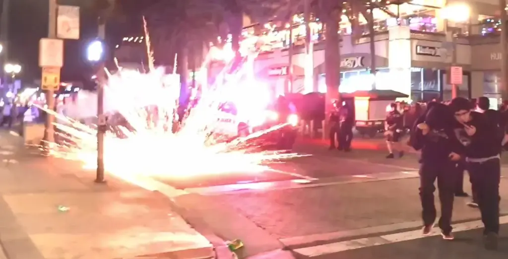 What appear to be fireworks explode Saturday night near police...